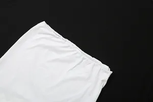 Close-up detail showing the clean finish and elastic waistband of a white slim-fit skirt
