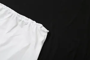 Macro detail view of the elastic waistband and soft fabric texture on a white slim-fit skirt