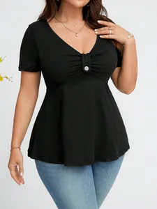 Dettaglio di un top nero da donna con scollo a V, vita segnata e bottone decorato.