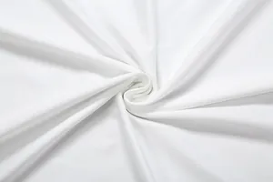 Detailed macro view of soft white fabric texture with elegant pleated swirls for clothing