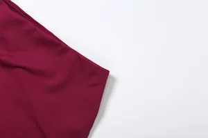 Macro detail view showing the wine red fabric texture and stitching of the skirt