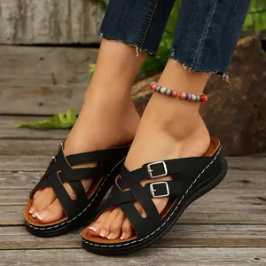 Side view of women's black platform wedge sandals with cross straps and buckles.