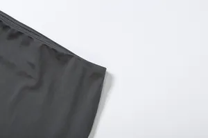 Detailed view of the smooth dark grey fabric and neat stitching on a slim-fit skirt