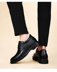 Professional detail view of black leather dress shoes with eight centimeter height increase