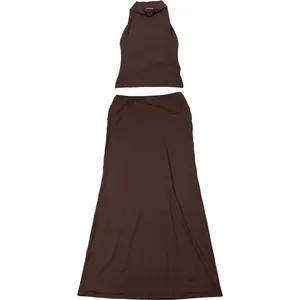 Flat lay of minimalist chocolate brown halter crop top and matching maxi skirt set
