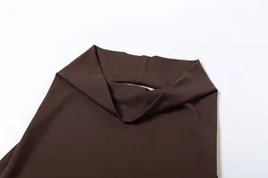 Close-up detail of the brown halter neck design with smooth elastic fabric texture