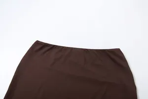 Close-up detail of smooth brown skirt waistband crafted in high-quality textile fabric.