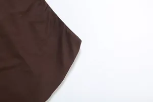 Close-up detail of the high-quality dark brown fabric material and hem of the skirt set