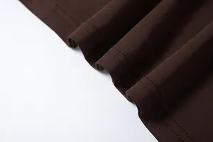 Detailed macro view showing the high-quality dark brown fabric texture and durable stitching