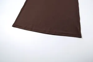 Macro detail showing the high-quality double-needle stitching on a dark brown garment hemline.