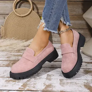 Elegant pink suede loafers with a chunky black lug sole for a modern casual look.