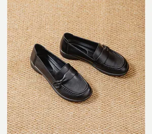 High angle shot of comfortable black women's loafers featuring an elegant leather bow detail