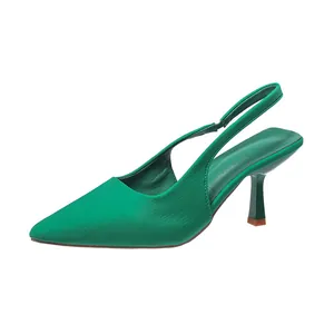 Side profile of elegant emerald green pointed-toe slingback pumps with kitten heels