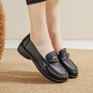 Comfortable black leather loafers with bow detail and slip-on design for women