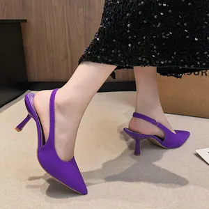 Detailed side view of elegant purple pointed-toe slingback heels with slim stiletto heels
