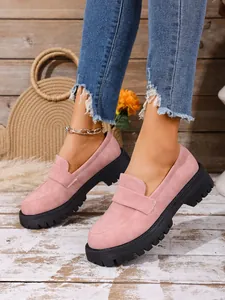 Fashionable women's pink suede loafers with thick lug soles and slip-on design