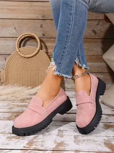 Detailed view of pink chunky loafers with thick black soles and slip-on design
