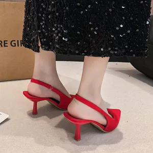 Side detail view of elegant red pointed-toe slingback kitten heels with stilettos