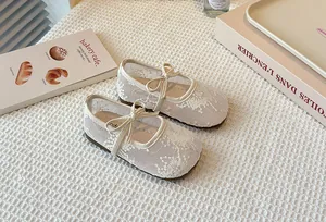 Detail of breathable lace mesh Mary Jane shoes for girls with elegant bow accent.