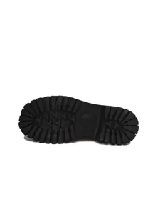 Detailed view of the durable black rubber lug sole tread pattern for these women's loafers