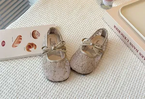 Detailed view of elegant lace mesh Mary Jane shoes for girls with cute bowknot detail.