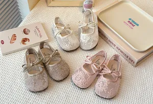 Detailed view of lace mesh Mary Jane shoes for girls with bow accents