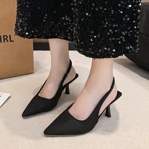 Close-up detail of elegant black pointed-toe slingback heels featuring a slim stiletto heel