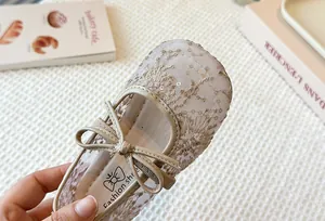 Close-up of girls' breathable lace mesh Mary Jane shoe with delicate bow and sequins.