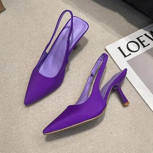 Close-up detail of elegant purple satin pointed-toe slingback sandals with slim heels