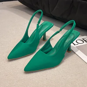Detailed view of elegant emerald green pointed-toe slingback heels with slim stiletto.