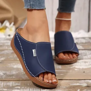 Stylish women's navy blue peep toe wedge platform slippers on rustic wooden background