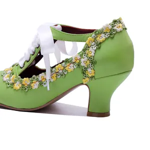 Close-up of green handmade leather Mary Jane heels with retro floral lace trim and ribbon laces.