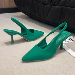 Side view of elegant green pointed-toe slingback pumps with slim high heels and texture