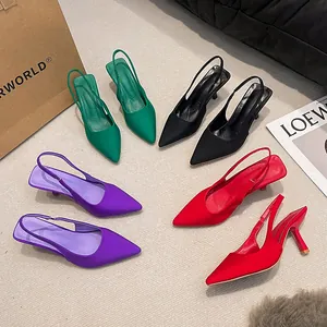 Detailed view of pointed-toe slingback high heels in green, black, purple and red colors