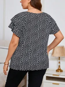 Back view of a stylish black and white polka dot print top featuring ruffle sleeve details