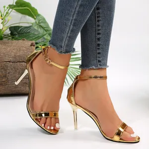 Detailed side view of gold metallic stiletto sandals with an elegant ankle strap