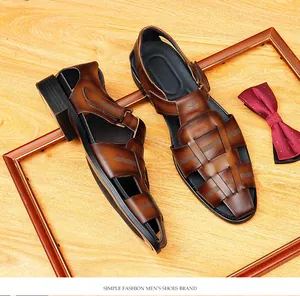 Detailed view of brown woven leather sandals for men on wooden background