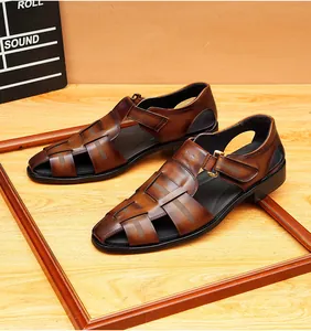 Close-up detail of brown leather fisherman sandals with a woven closed-toe design