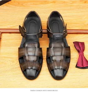 Detailed macro view of woven brown leather men's closed-toe sandals on wooden background