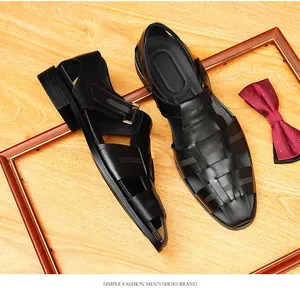 Detailed view of black woven leather men's closed-toe sandals on a wooden background