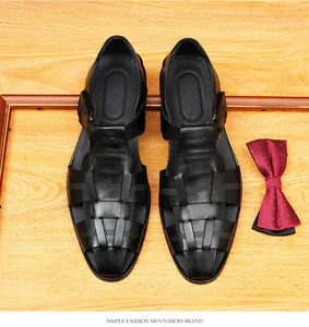 Close-up of black woven leather men's sandals showing texture and round toe detail