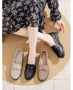 Detailed view of breathable leather loafers with bow accents and hollow patterns.