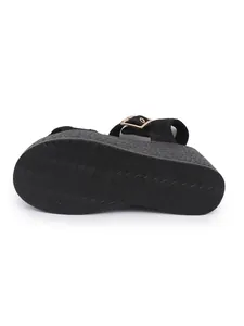 Close-up bottom view of black platform wedge sandals featuring anti-slip wavy texture sole