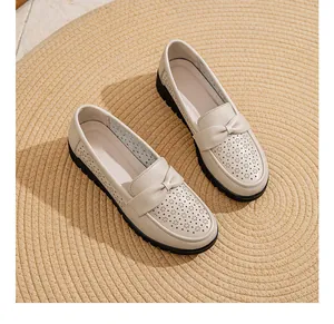Detailed view of beige genuine leather loafers for women with bow and hollow design
