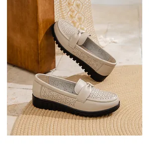 Close-up detail of beige breathable hollow leather loafers for middle-aged women's casual wear