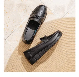 Detailed view of breathable black leather loafers with elegant bow and soft sole