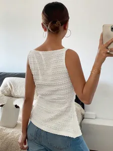 Detail shot showing the intricate textured back of a white sleeveless fashion tank top.