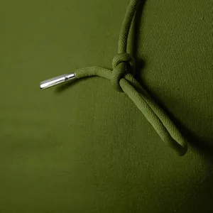 Close-up of drawstring and textured fabric on men's olive green hoodie.