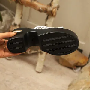 Detailed view of the anti-slip black platform sole on white mesh chunky heel mule