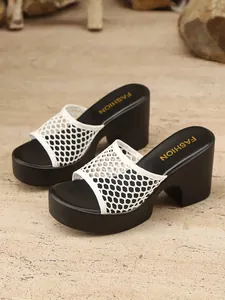 Detailed view of women's white mesh platform slides featuring elegant black block heels